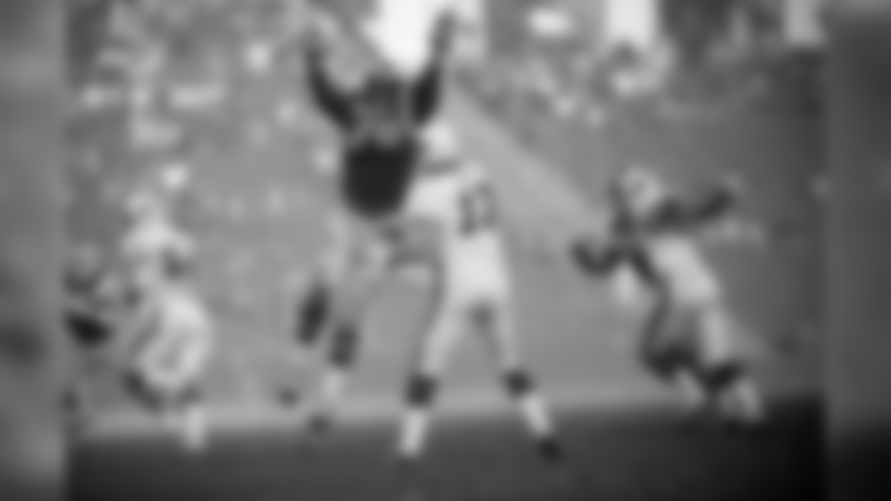 1975: Cardinal QB Jim Hart throws a pass as Rams DL Cody Jones jumps into his throwing lane