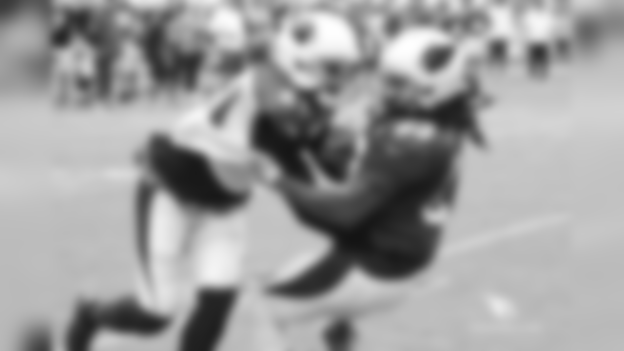 CB Patrick Peterson (left) brings down RB Chris Johnson