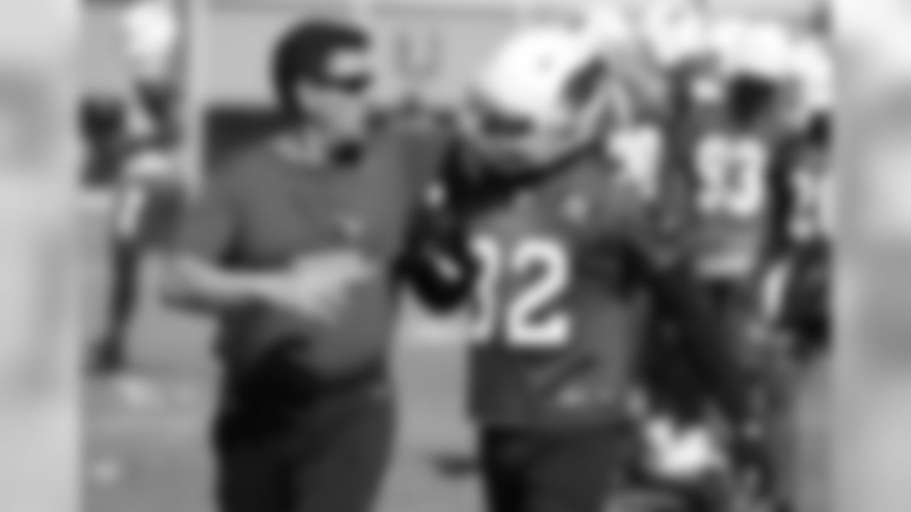 Defensive backs coach Nick Rapone congratulates S Tyrann Mathieu after a deflection