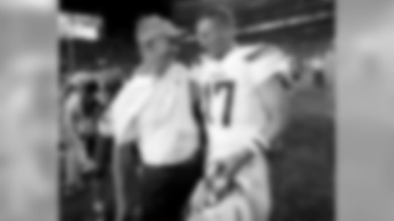Los Angeles Chargers quarterback Philip Rivers (17) greets Denver Broncos offensive coordinator Mike McCoy after an NFL football game, Monday, Sept. 11, 2017, in Denver. The Broncos won 24-21. (AP Photo/David Zalubowski)
