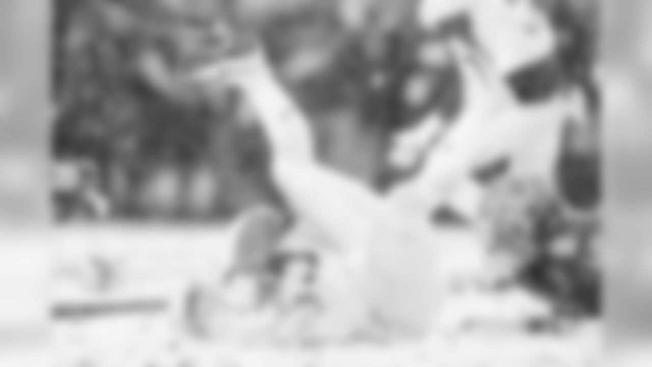 Army RB Darnell Woolfolk falls into a pile of snow.