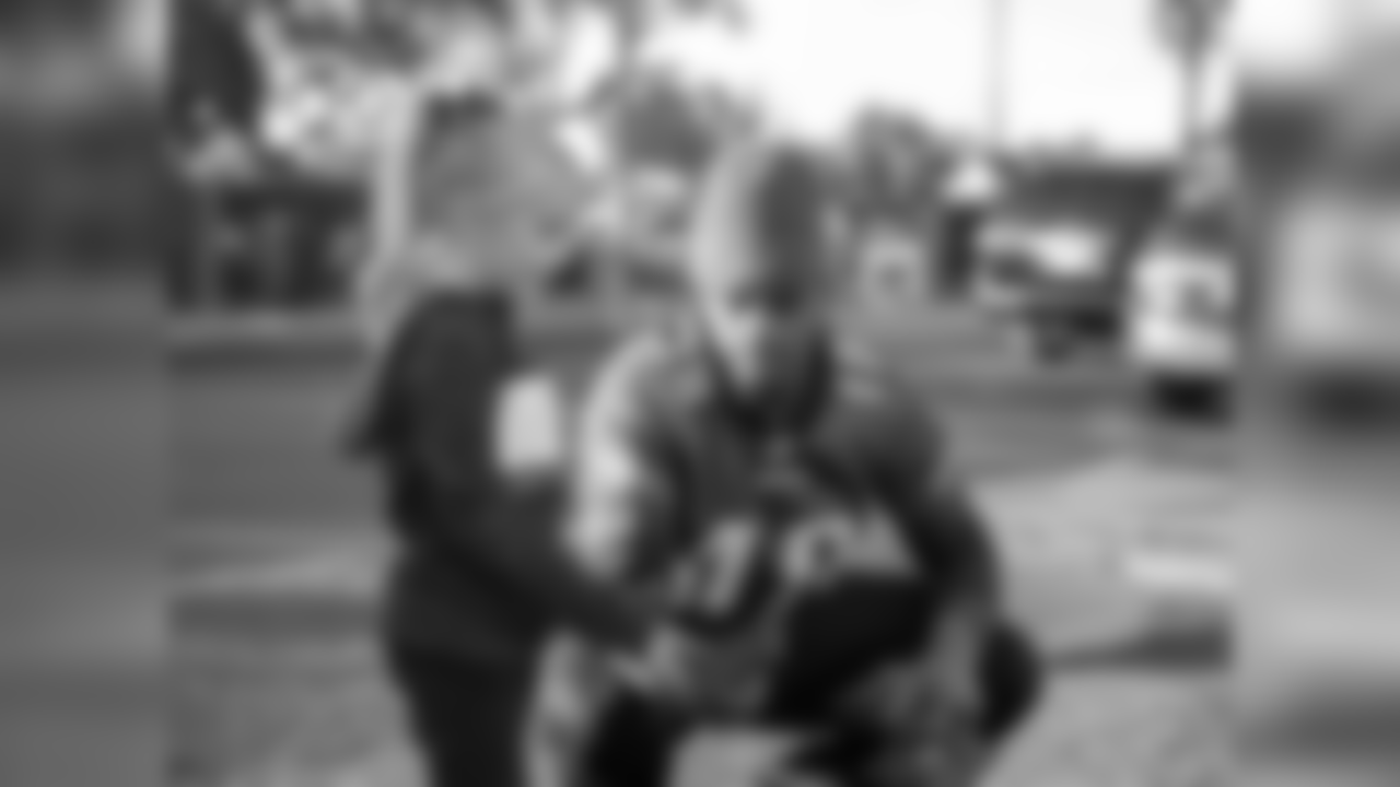 WR Shelton Gibson chats with a child.