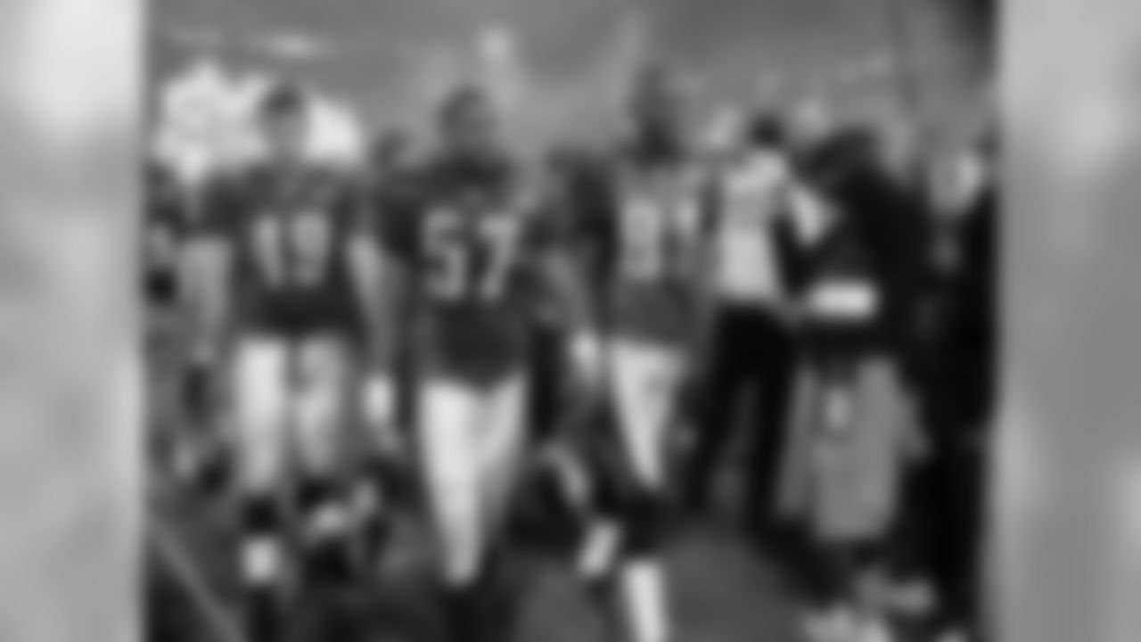Josh Parry, Keith Adams and Owens walk off the field after the 24-21 loss, fit to fight another day.