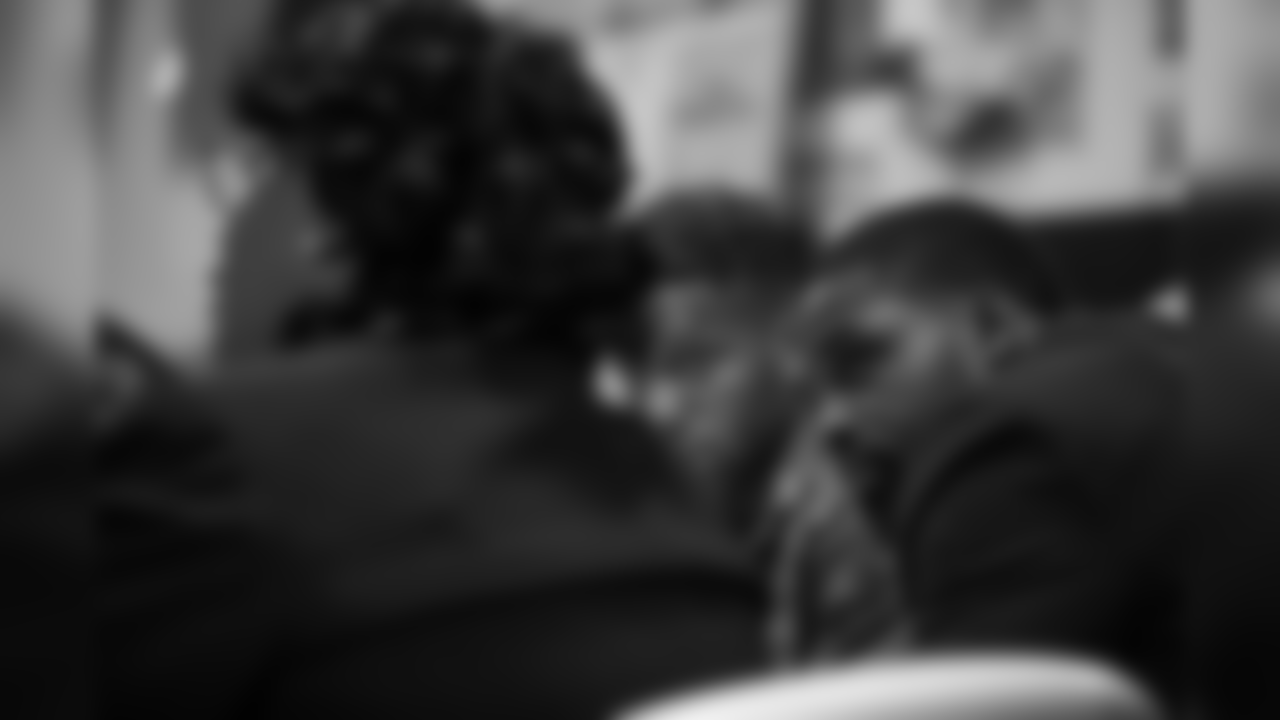Torrey Smith listens to Reverend Michelle Simmons, founder and CEO of Why Not Prosper.
