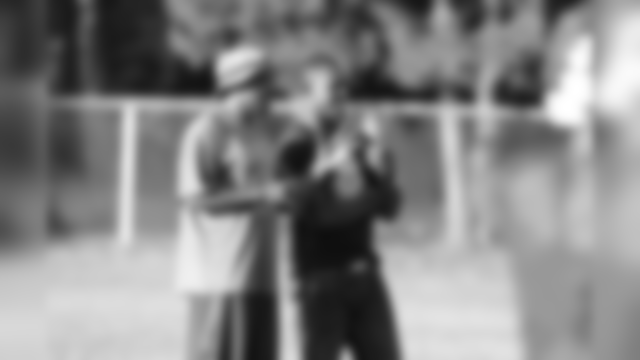 Lito Sheppard speaks with Raines coach Charles Owens