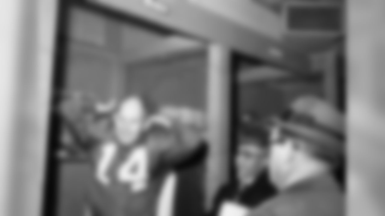 New York Giant quarterback Y.A. Tittle wears a smile as he pulls off his jersey after leading Giants to stunning 38-21 win over the Philadelphia Eagles in New York's Yankee Stadium on Nov. 12, 1961.