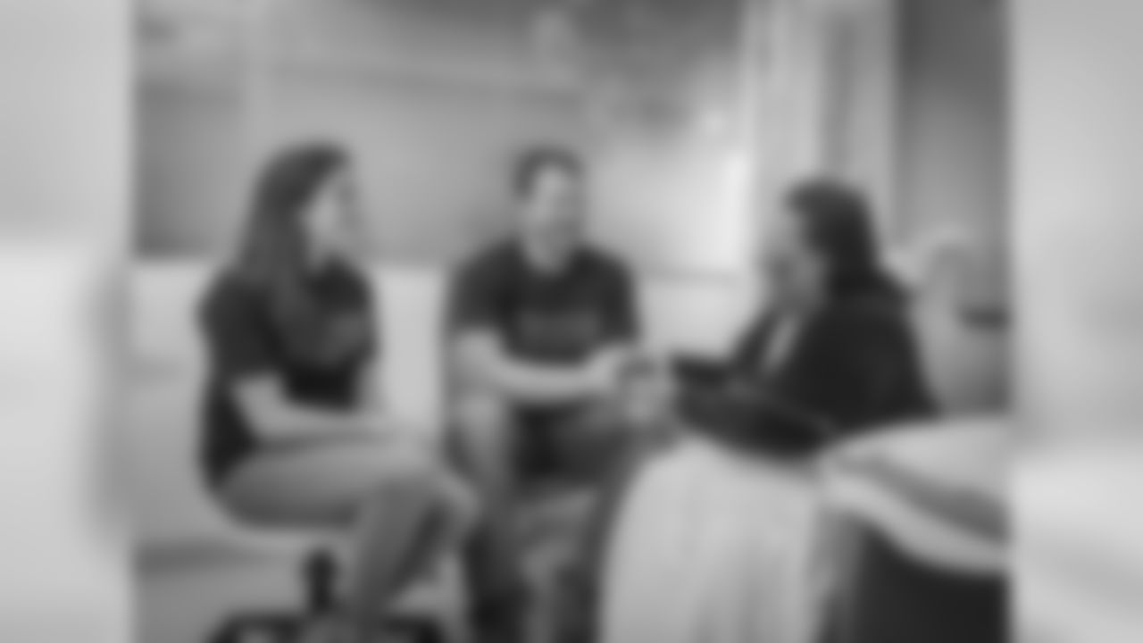 New England Patriots offensive lineman, Nate Solder and his wife, Lexi Allen came to meet breast cancer patients on Yawkey 9 and sign footballs and give away pampering invitations. Photo by Sam Ogden.