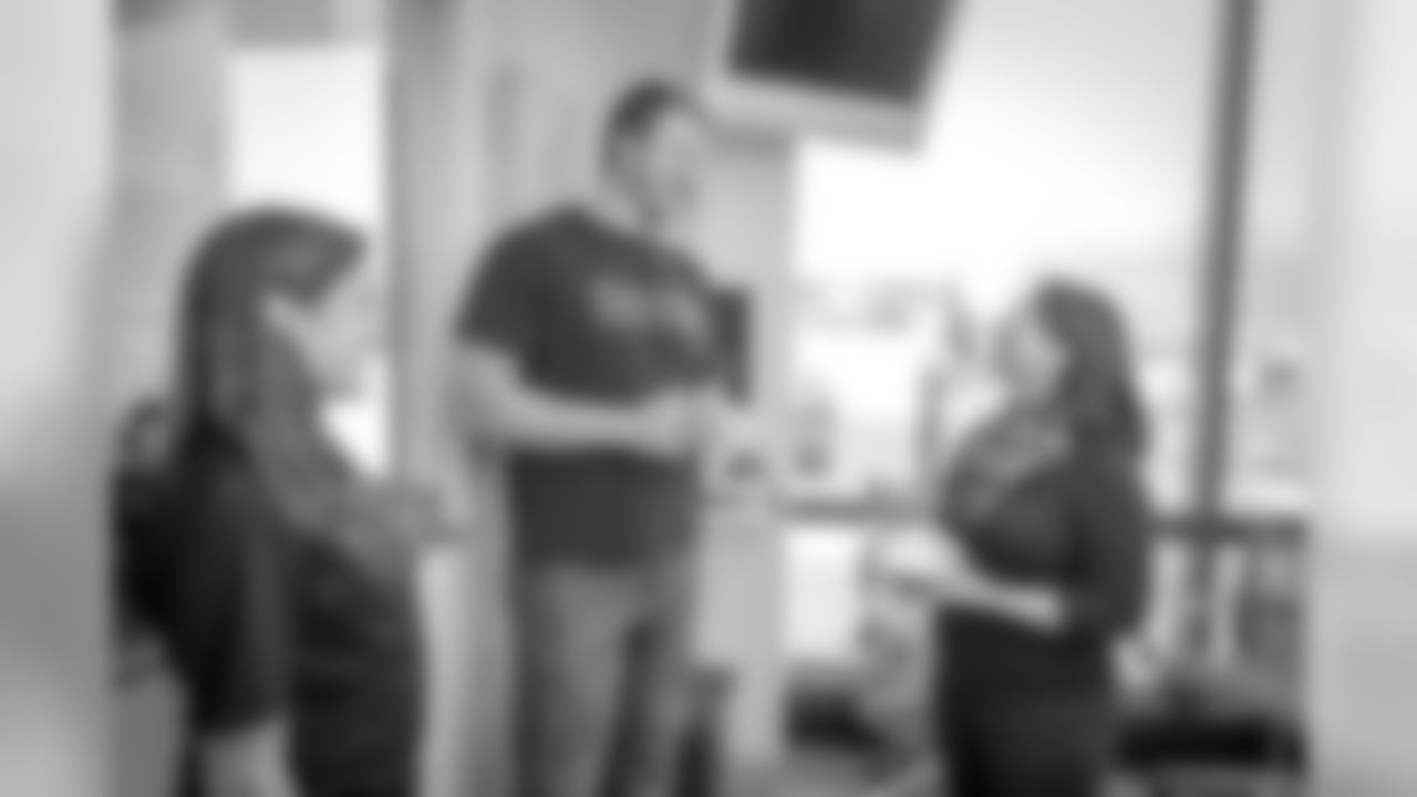 New England Patriots offensive lineman, Nate Solder and his wife, Lexi Allen came to meet breast cancer patients on Yawkey 9 and sign footballs and give away pampering invitations. Photo by Sam Ogden.