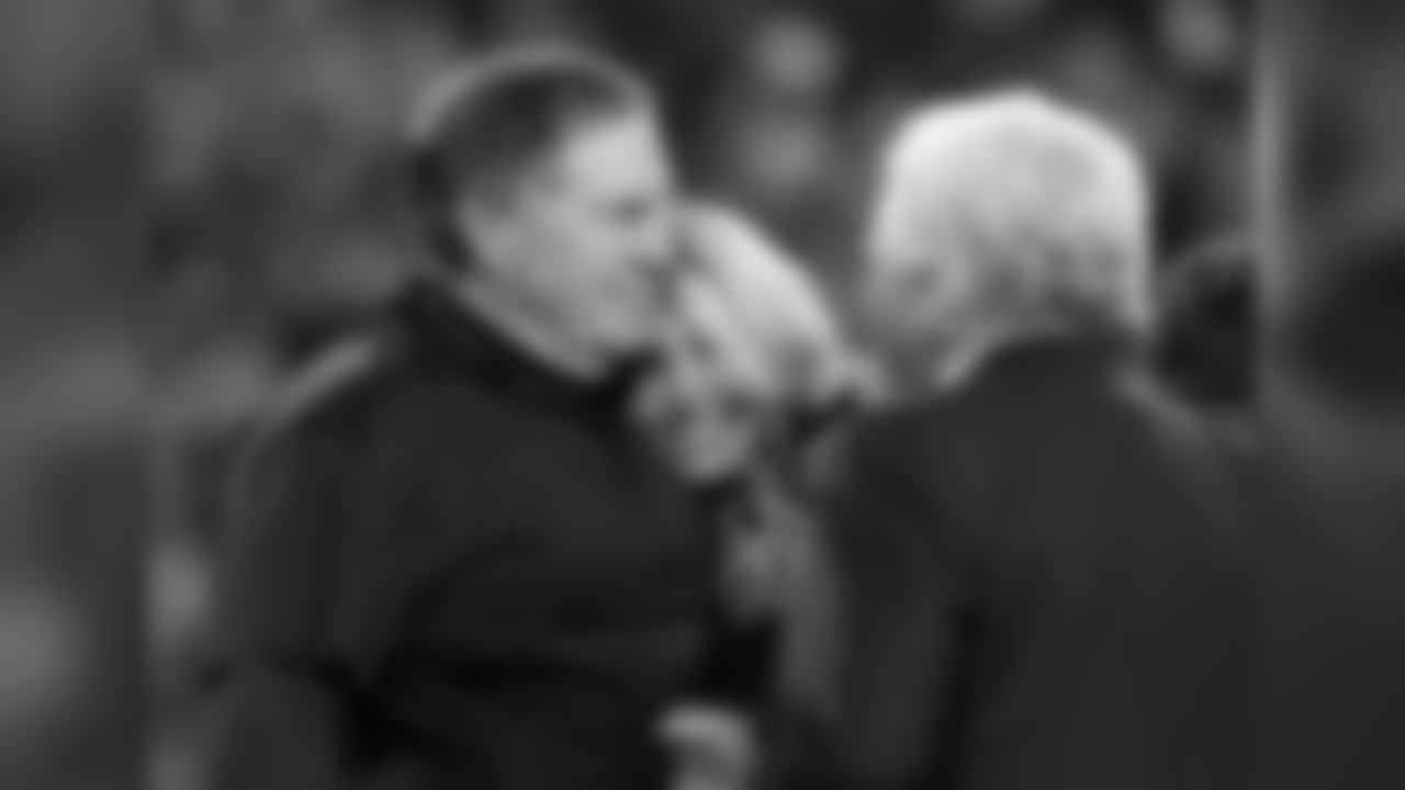 New England Patriots head coach Bill Belichick, hugs his girlfriend Linda Holliday as he talks to team owner Robert Kraft after winning the AFC championship NFL football game against the Jacksonville Jaguars, Sunday, Jan. 21, 2018, in Foxborough, Mass. The Patriots won 24-20. (AP Photo/Winslow Townson)