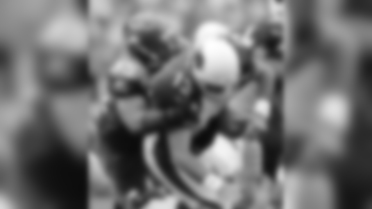 * FILE * Arizona Cardinals quarterback Kurt Warner loses control of the ball but regains control as he is sacked by Seattle Seahawks' Darryl Tapp during the fourth quarter of a football game in Seattle, in this Sept. 17, 2006 file photo. One week after Warner was named NFC offensive player of the week in Arizona's season-opening victory over San Francisco, he was blamed, in part, by his coach for the offense's struggles in Sunday's 21-10 loss at Seattle. (AP Photo/John Froschauer)