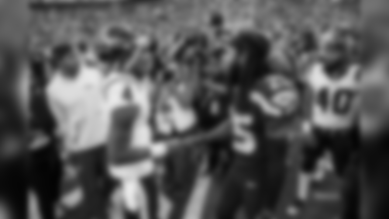 Houston quarterback Deshaun Watson and Richard Sherman meet at midfield after the game.