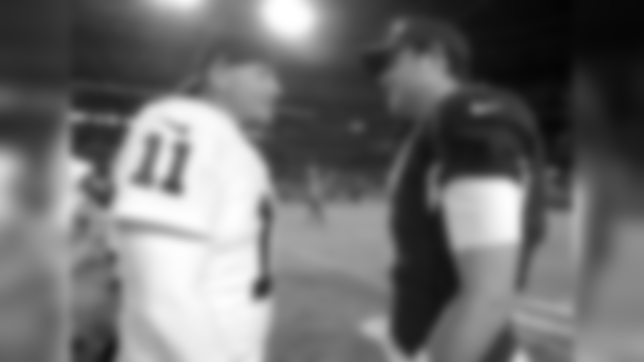 Oakland Raiders kicker Sebastian Janikowski (11) and Arizona Cardinals quarterback Carson Palmer (3) after an NFL preseason football game, Friday, Aug. 12, 2016, in Glendale, Ariz. (AP Photo/Rick Scuteri)
