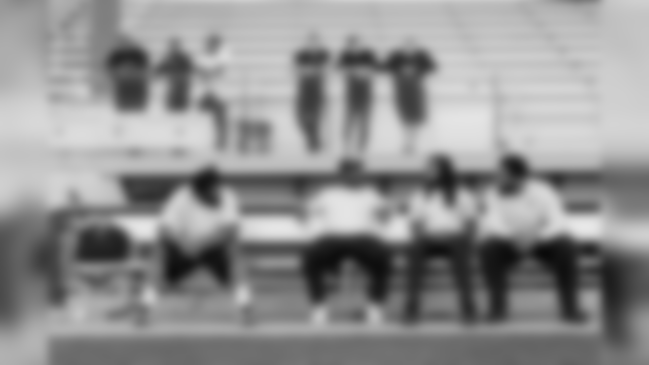 While the offense runs through plays, members of the defense including Sheldon Richardson, Cliff Avril, Richard Sherman and Michael Bennett sit on a nearby bench waiting their for their turn.