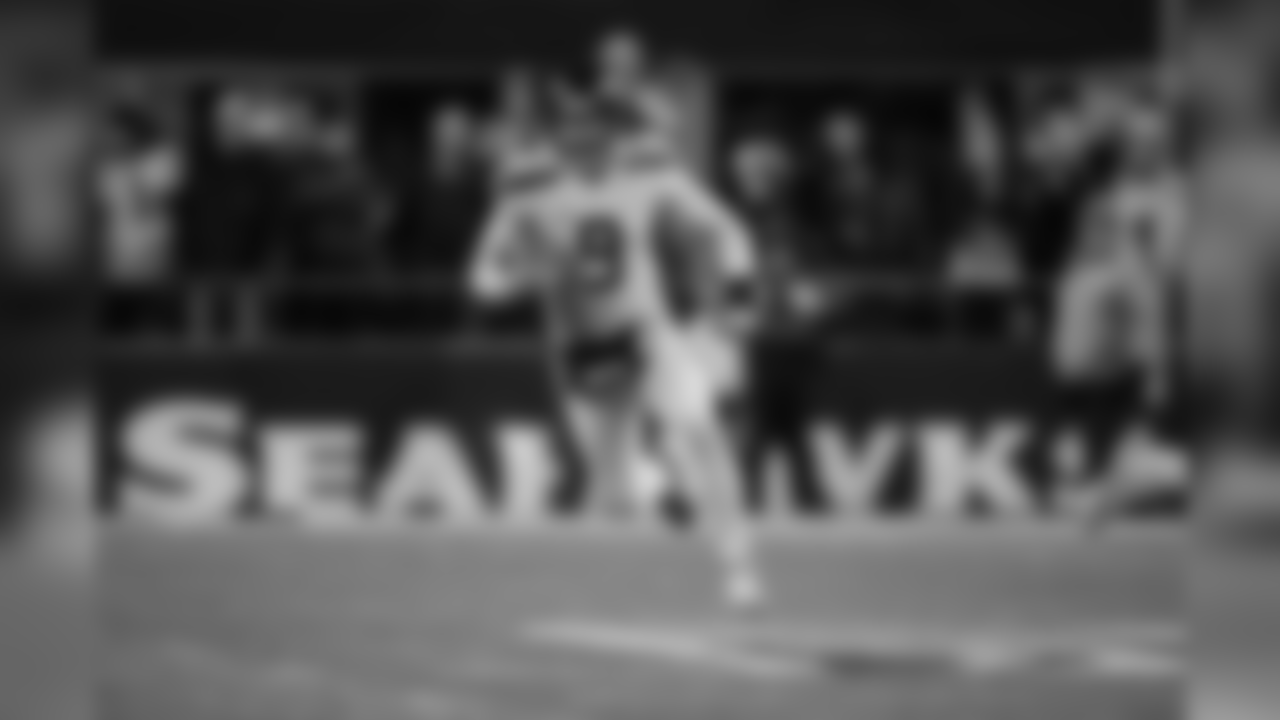 Jon Ryan runs the ball up the field on a fake punt in the fourth quarter.