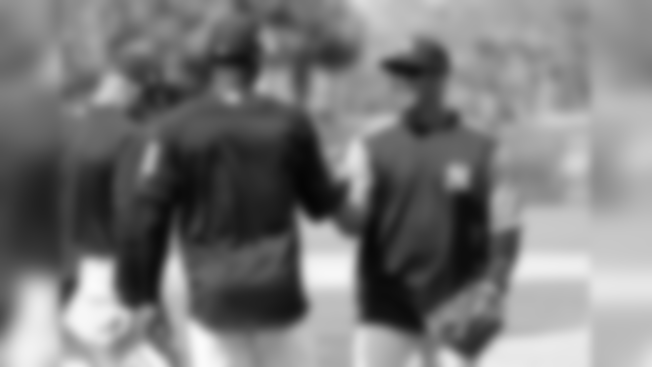Seattle Seahawks NFL football team quarterback Russell Wilson, right, shakes hands with shortstop Didi Gregorius (18) at New York Yankees baseball spring training camp, Monday, Feb. 26, 2018, in Tampa, Fla. (AP Photo/Lynne Sladky)