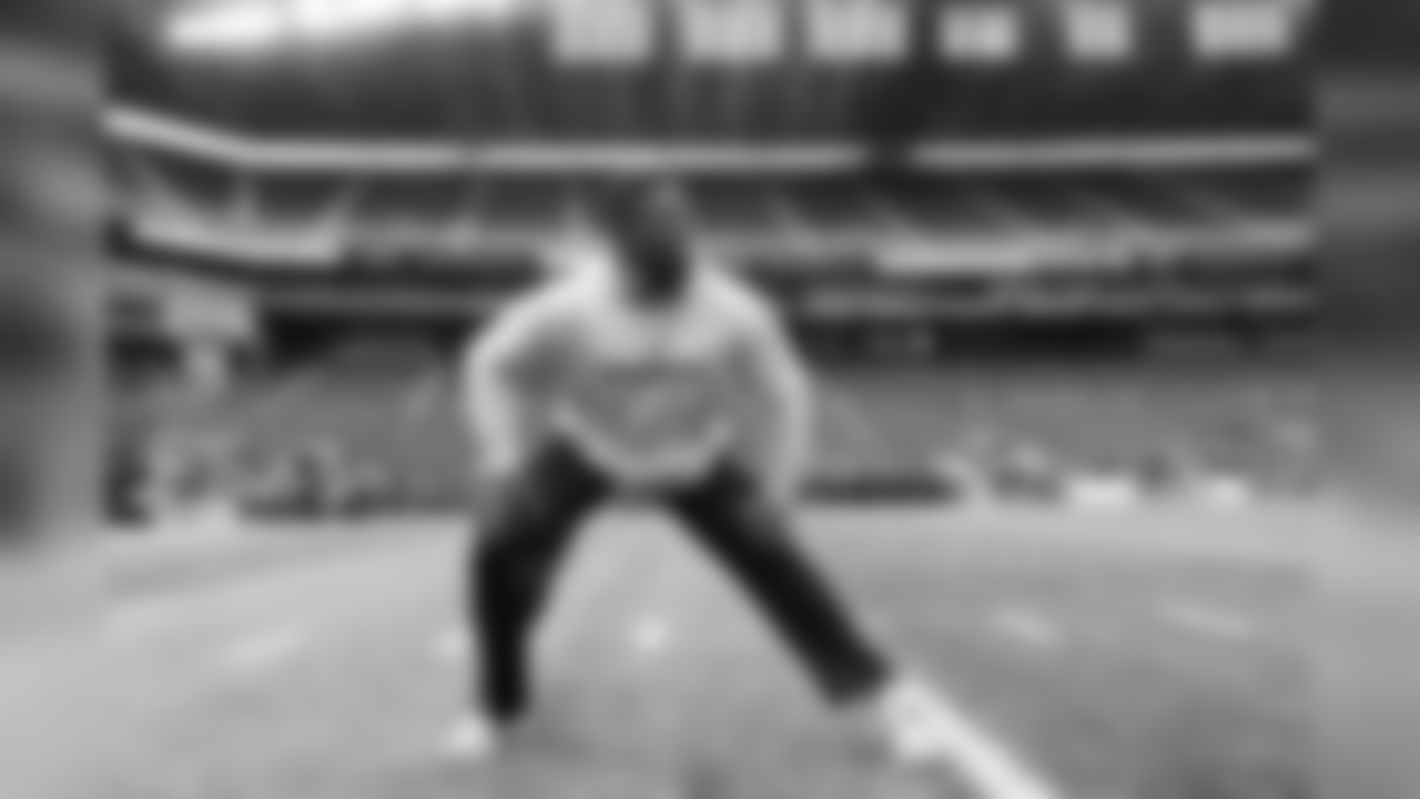 Germain Ifedi stretches on the field before the start of the game.