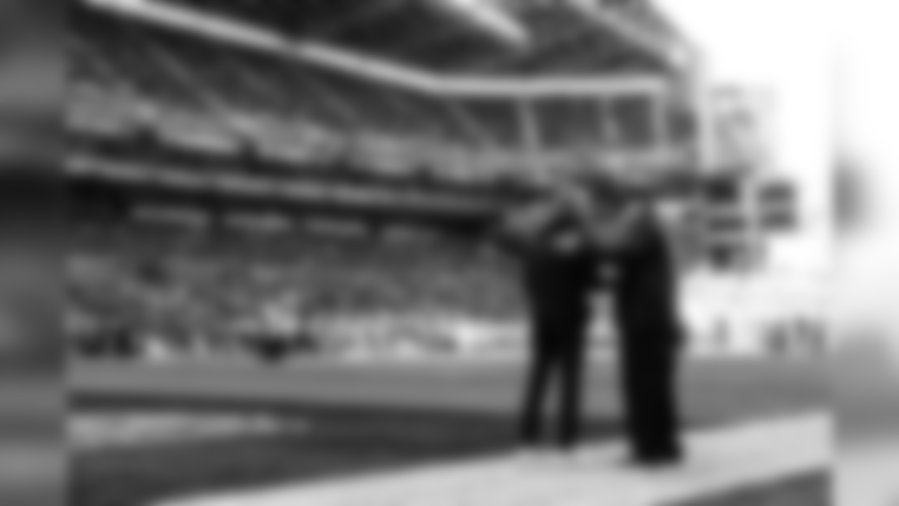 Seahawks head coach Pete Carroll and team owner Paul Allen shake hands on the field before the game.