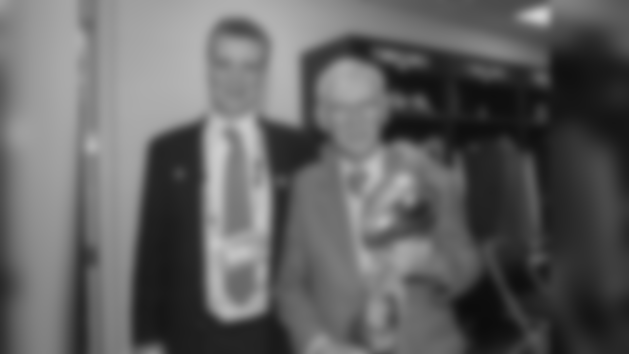 Dan Rooney poses for a photo with his son Art Rooney II in the locker room with the Lombardi trophy after winning Super Bowl XL.