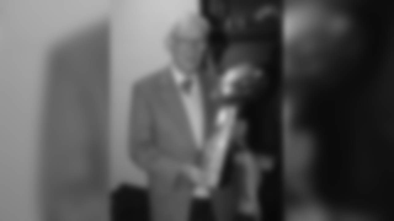 Dan Rooney stands in the locker room with the Lombardi trophy after winning Super Bowl XL.