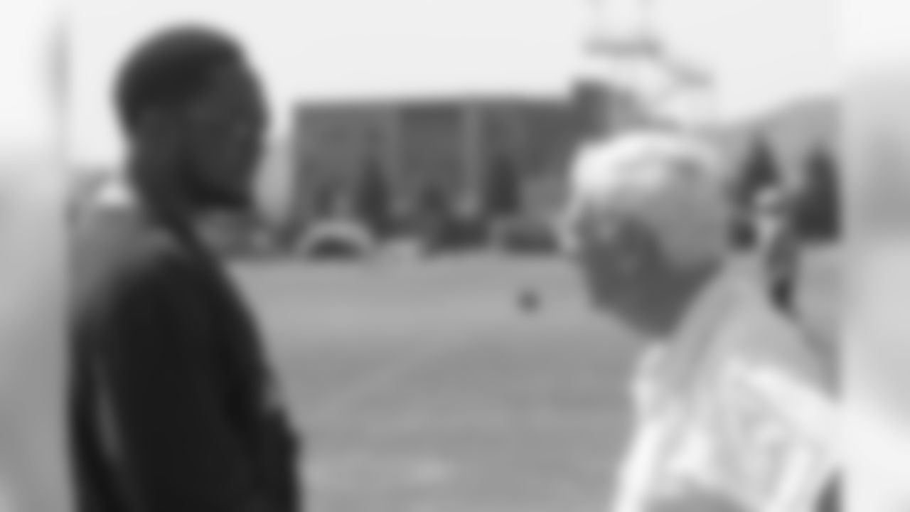 Dan Rooney speaks with Head Coach Mike Tomlin on the practice field during the 2007 Rookie Mini-Camp.