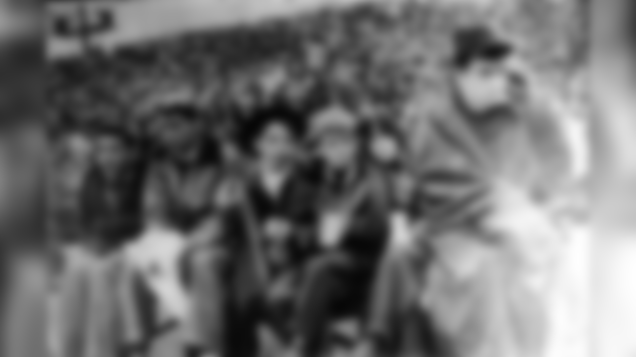Dan Rooney, pictured far right, sits on the bench as a ball boy.