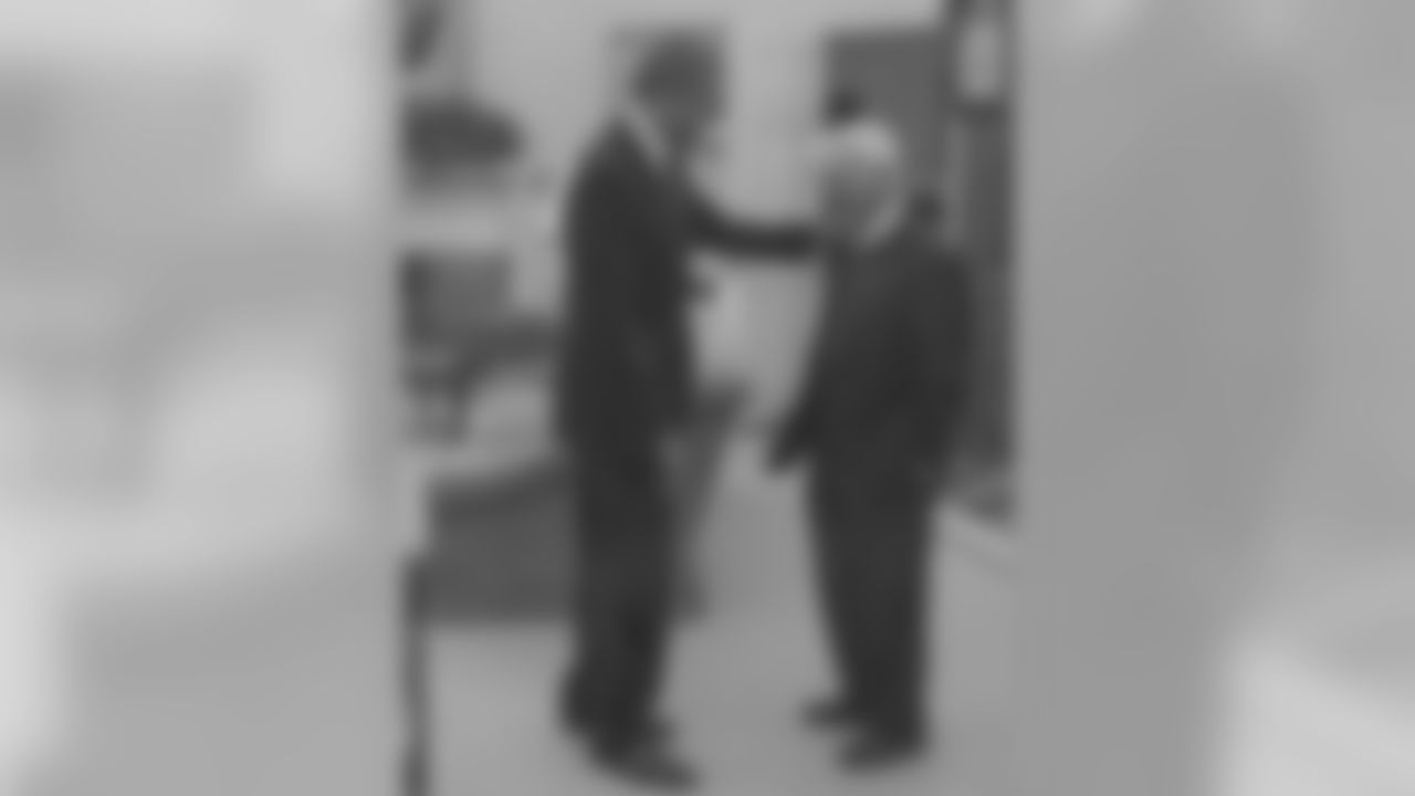 Dan Rooney stands in the oval office with President Barack Obama.
