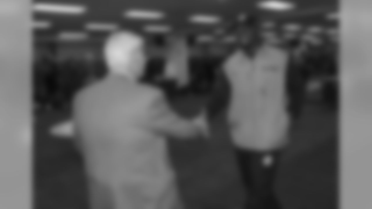 Dan Rooney shakes hands with Head Coach Mike Tomlin in the Steelers locker room after a Divisional Round win against the San Diego Chargers January 11, 2009.