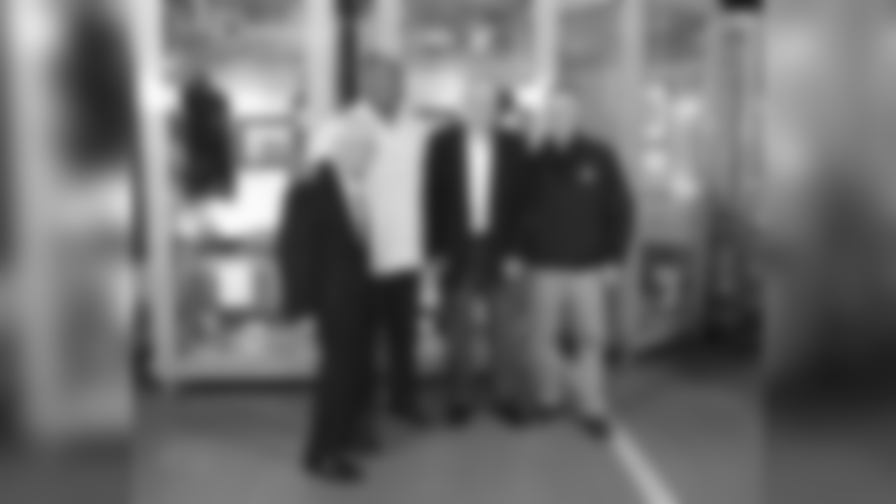 Dan Rooney stands with Dermontti Dawson, Jack Butler and Art Rooney II during a locker unveiling for the newest members to the Pro Football Hall of Fame.
