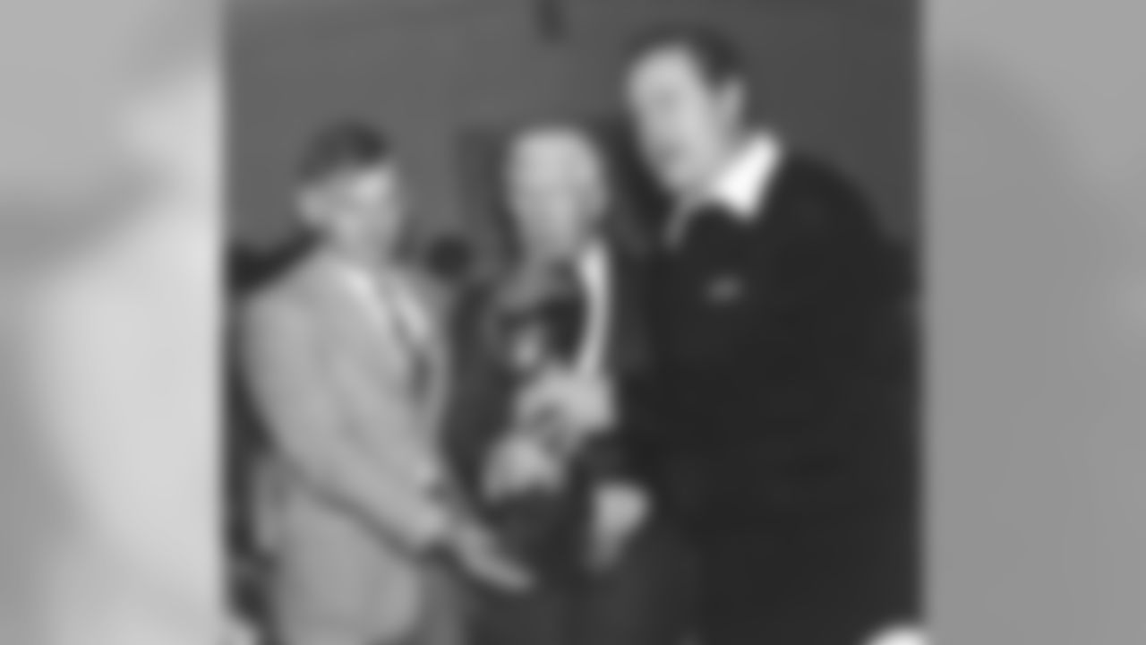 Dan Rooney holds the Lombardi trophy with his father Art Rooney and Chuck Noll after winning Super Bowl XIV.
