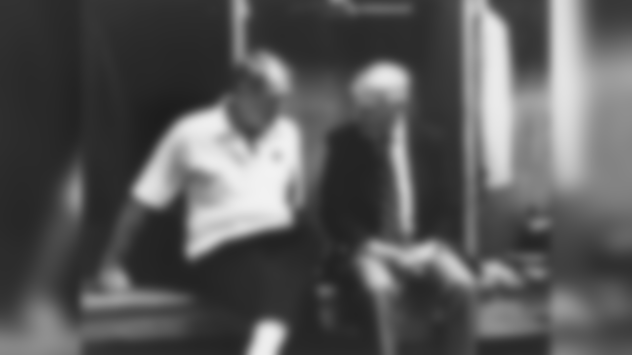 Candid shot of Steelers owner Dan Rooney sitting with Steelers head coach Chuck Noll in the locker room after the Dallas Cowboys defeated the Steelers.