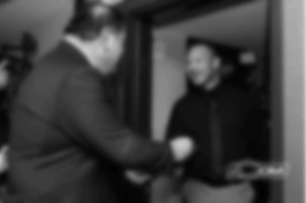 David Baker hands the Do Not Disturb sign back to Urlacher after he delivered the good news.