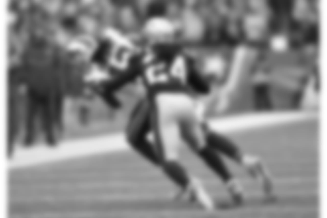 WR Kelvin Benjamin (No. 13) hauls in a pass in front of a Patriots defender