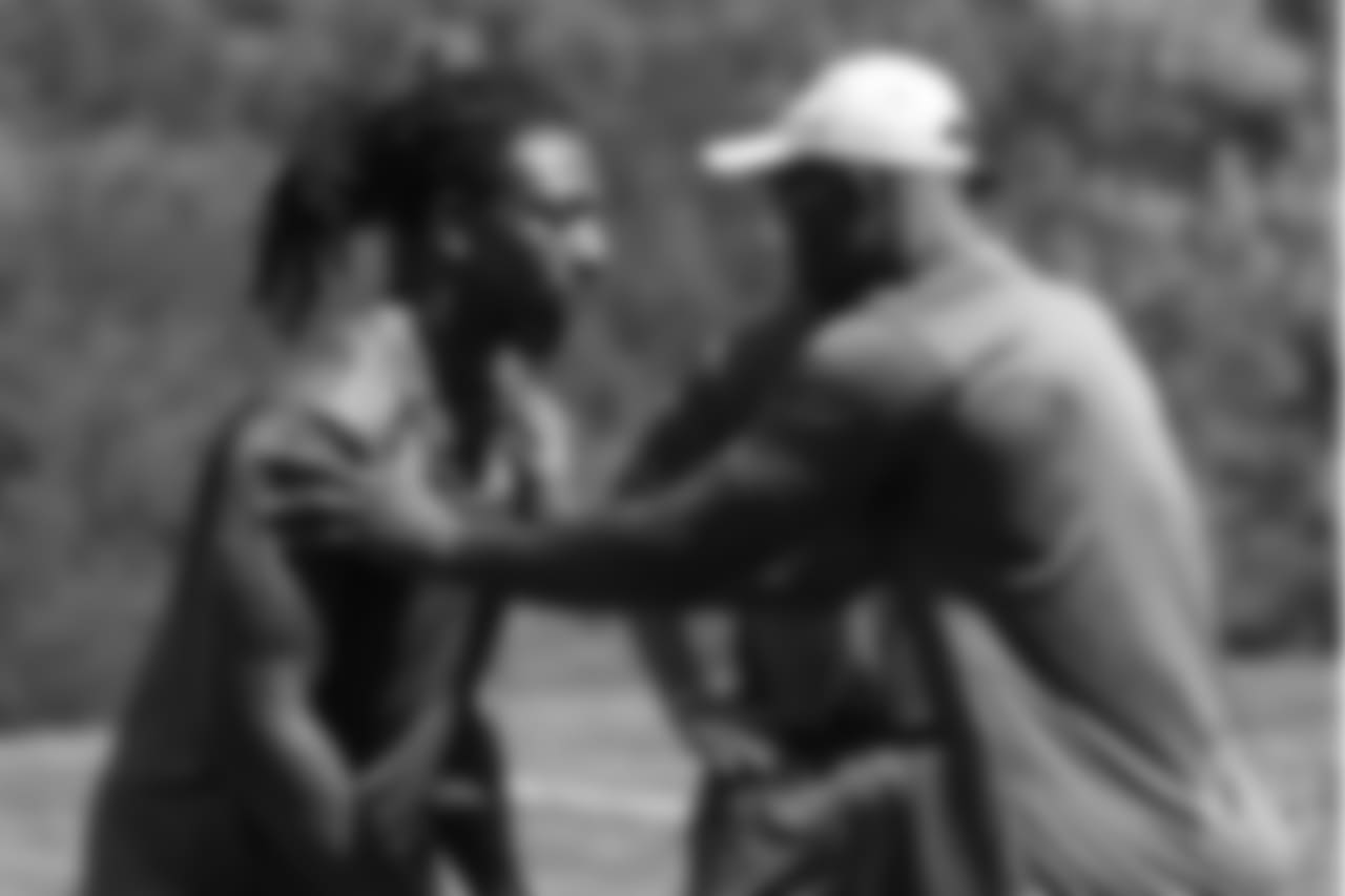 Von Miller works with Bud Dupree during the on-field portion of Von Miller's Pass Rush Summit, which included hands-on instruction and drills, on June 28, 2018.