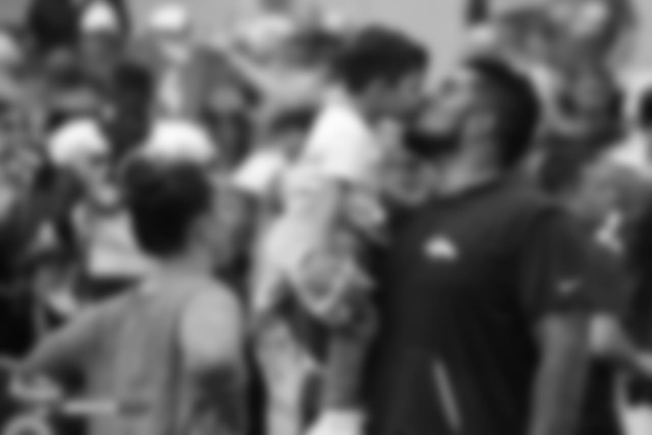 Nose tackle Kyle Peko (90) kisses his son at the sixth day of training camp on August 3, 2018, at UCHealth Training Center.