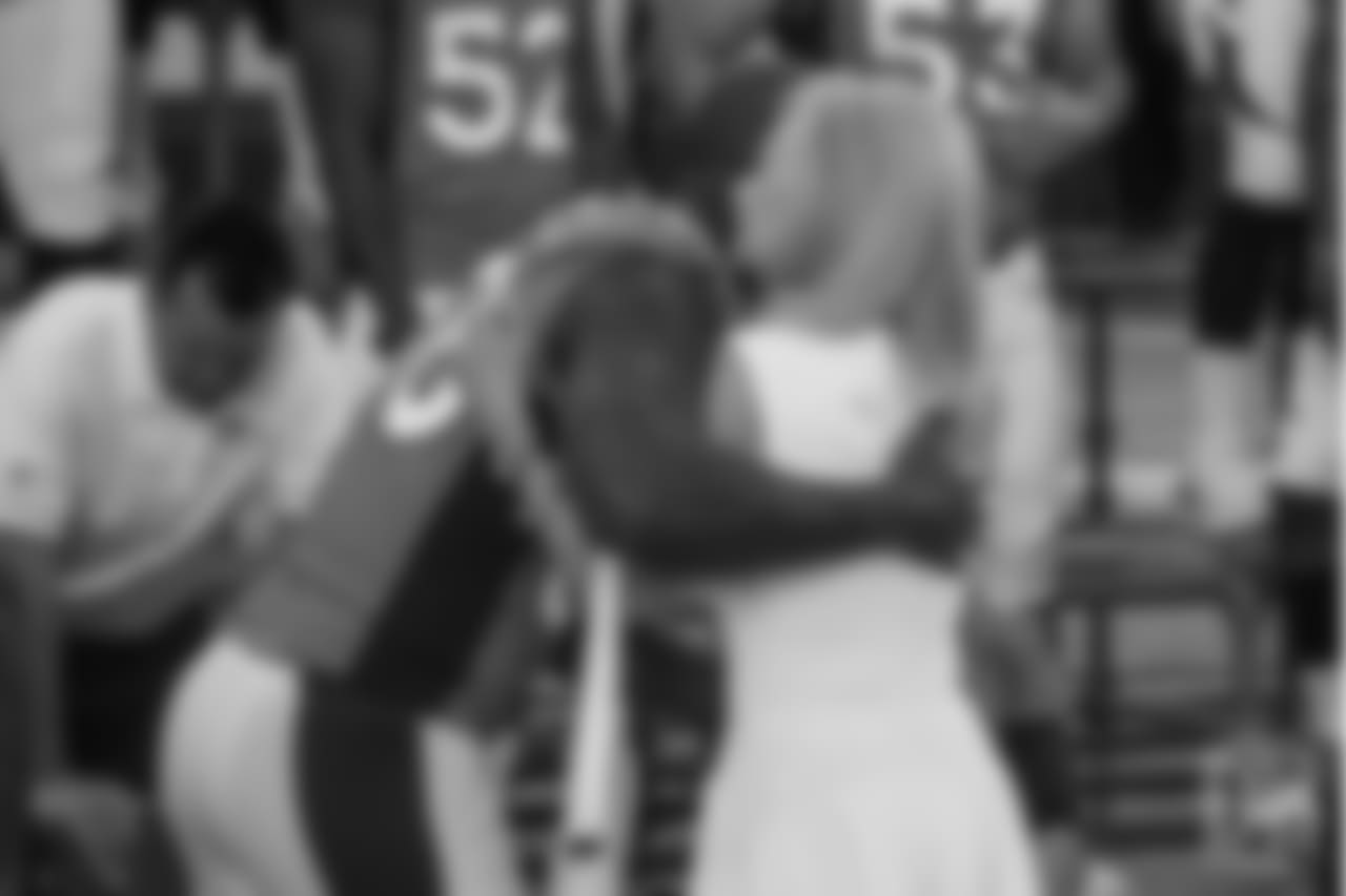 Von Miller gives Annabel Bowlen a hug at the Broncos' 2016 team photo picture day at the Pat Bowlen Fieldhouse.