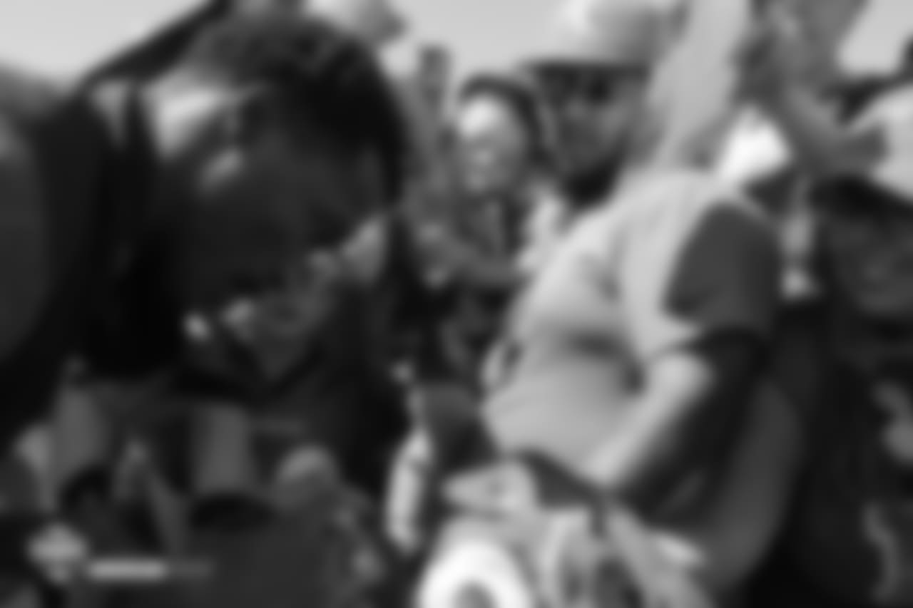 A young boy looks on as wide receiver Demaryius Thomas (88) signs autographs after the 11th day of training camp on August 9, 2018, at UCHealth Training Center.