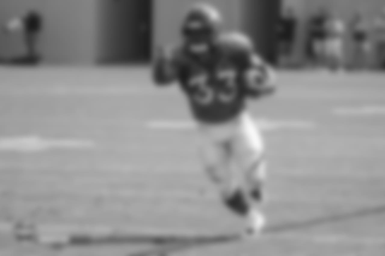 Running back De'Angelo Henderson Sr. (33) points upfield to set up a block during the ninth day of training camp on August 7, 2018, at UCHealth Training Center.