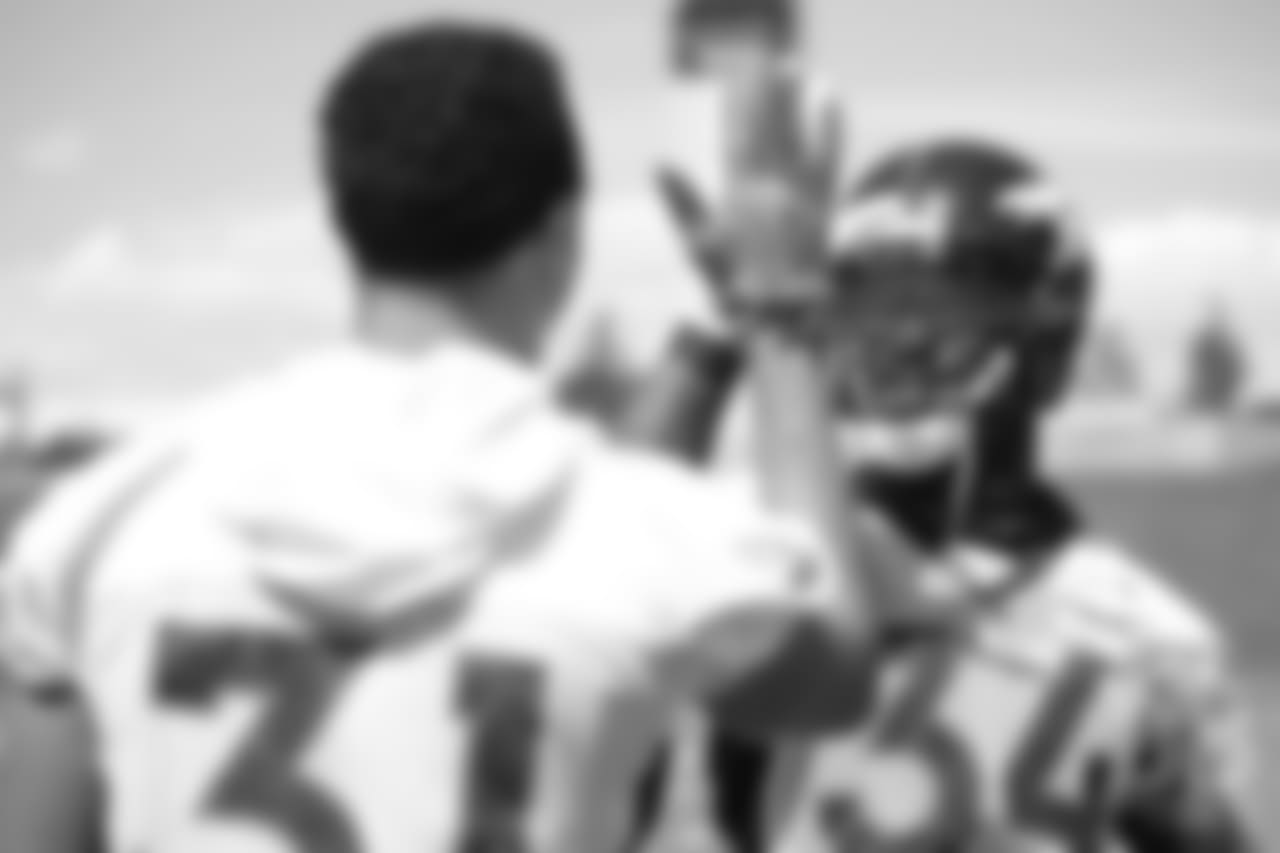 safety Justin Simmons (31) and safety Will Parks (34) high-five before practice at the eighth day of OTAs on June 5, 2018.