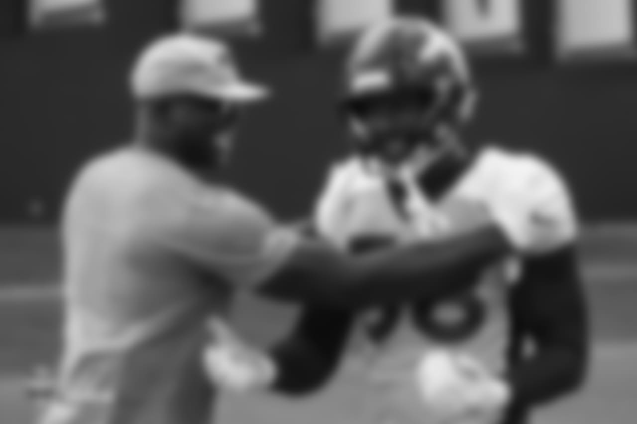 Pass Rush Consultant and former Broncos outside linebacker DeMarcus Ware jokes around with outside linebacker Von Miller (58) at the sixth day of training camp on August 3, 2018, at UCHealth Training Center.
