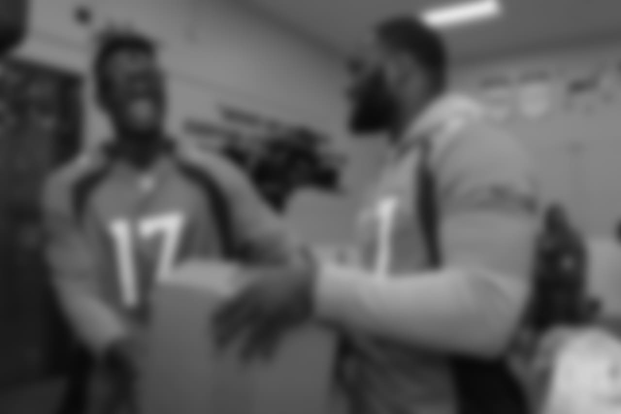 Wide receiver DaeSean Hamilton (17) laughs as he receives a completed food package from running back Royce Freeman (37) at the Food Bank of the Rockies at the Broncos' third annual Rookie Community Service Day on June 11, 2018.