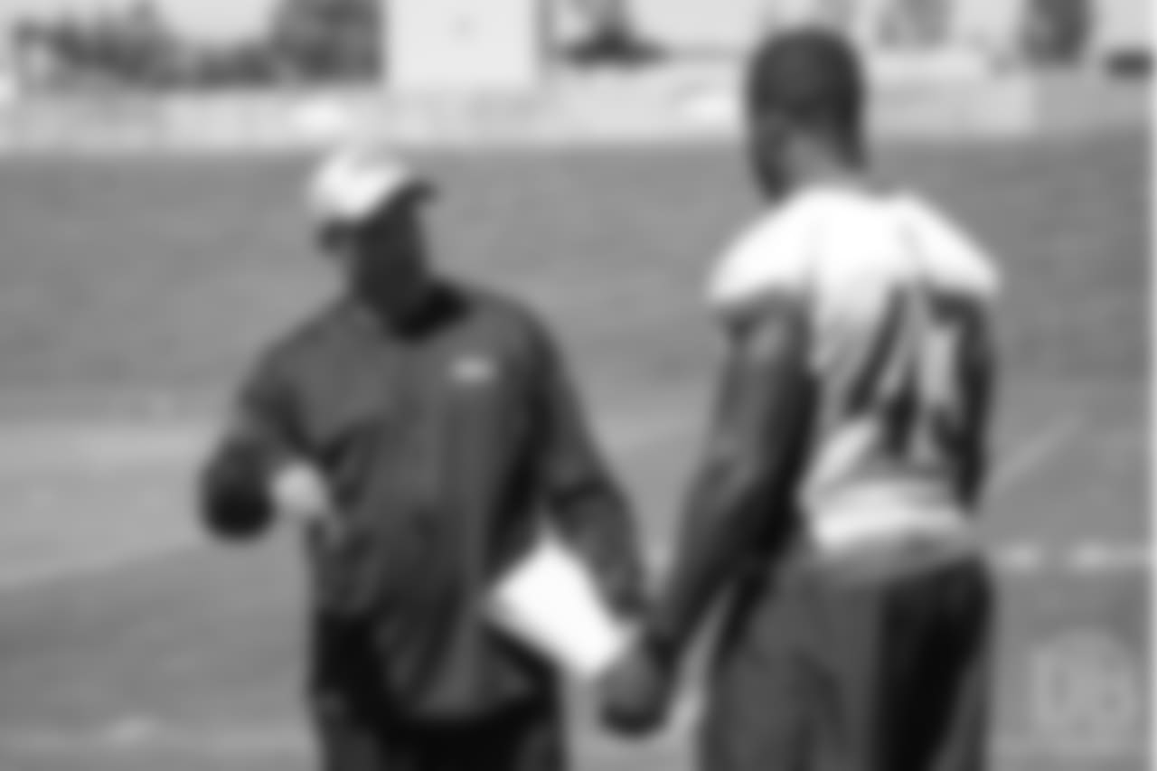 Special Teams Coordinator Tom McMahon talks with inside linebacker Joseph Jones (43) before the 10th and final day of OTAs on June 7, 2018 at UCHealth Training Center.