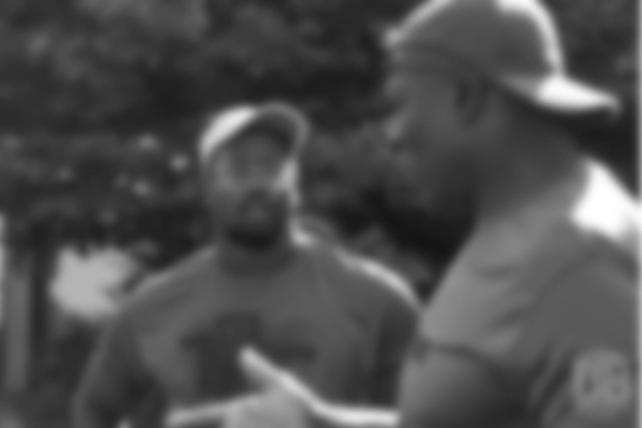 Von Miller listens as Bruce Smith gives instruction during the on-field portion of Von Miller's Pass Rush Summit, which included hands-on instruction and drills, on June 28, 2018.