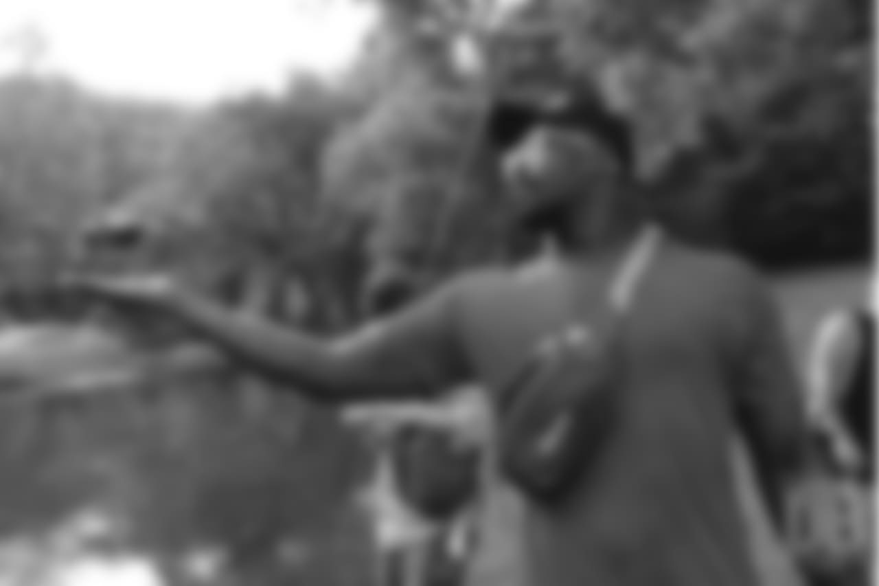 Von Miller holds out his hand as a landing pad for a tiny drone at the fishing portion of Von Miller's Pass Rush Summit at Dogwood Canyon Nature Park on June 28, 2018.