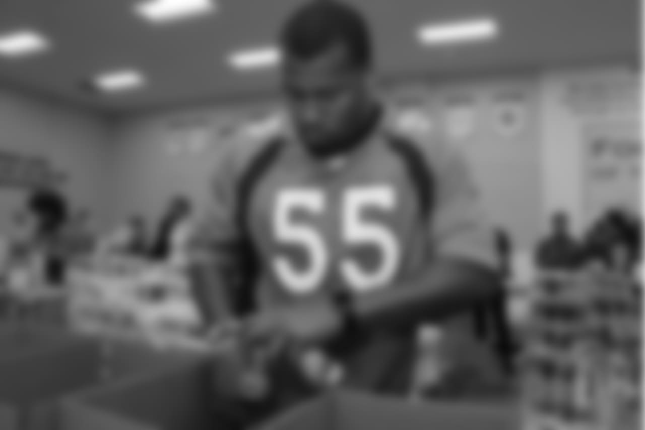 Outside linebacker Bradley Chubb (55) packs food into boxes at the Food Bank of the Rockies at the Broncos' third annual Rookie Community Service Day on June 11, 2018.
