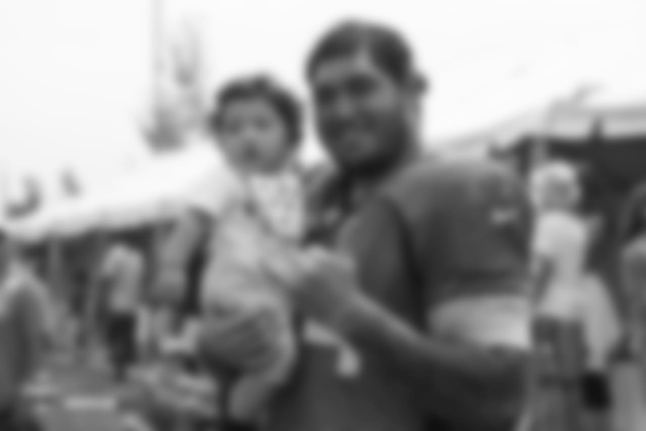 Tackle Jeremiah Poutasi (74) poses for a photo with his child at the sixth day of training camp on August 3, 2018, at UCHealth Training Center.