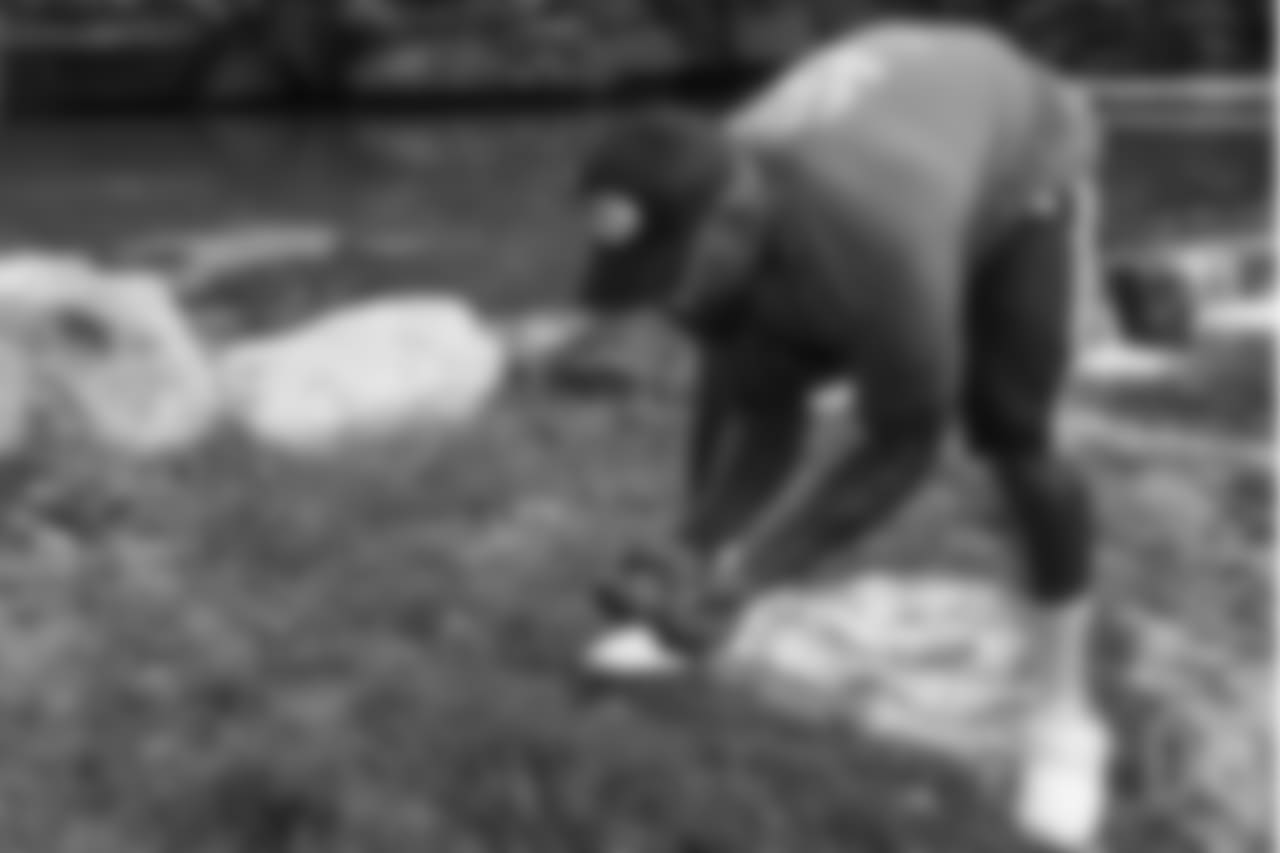 Von Miller tries to get a handle on his slippery trout at the fishing portion of Von Miller's Pass Rush Summit at Dogwood Canyon Nature Park on June 28, 2018.