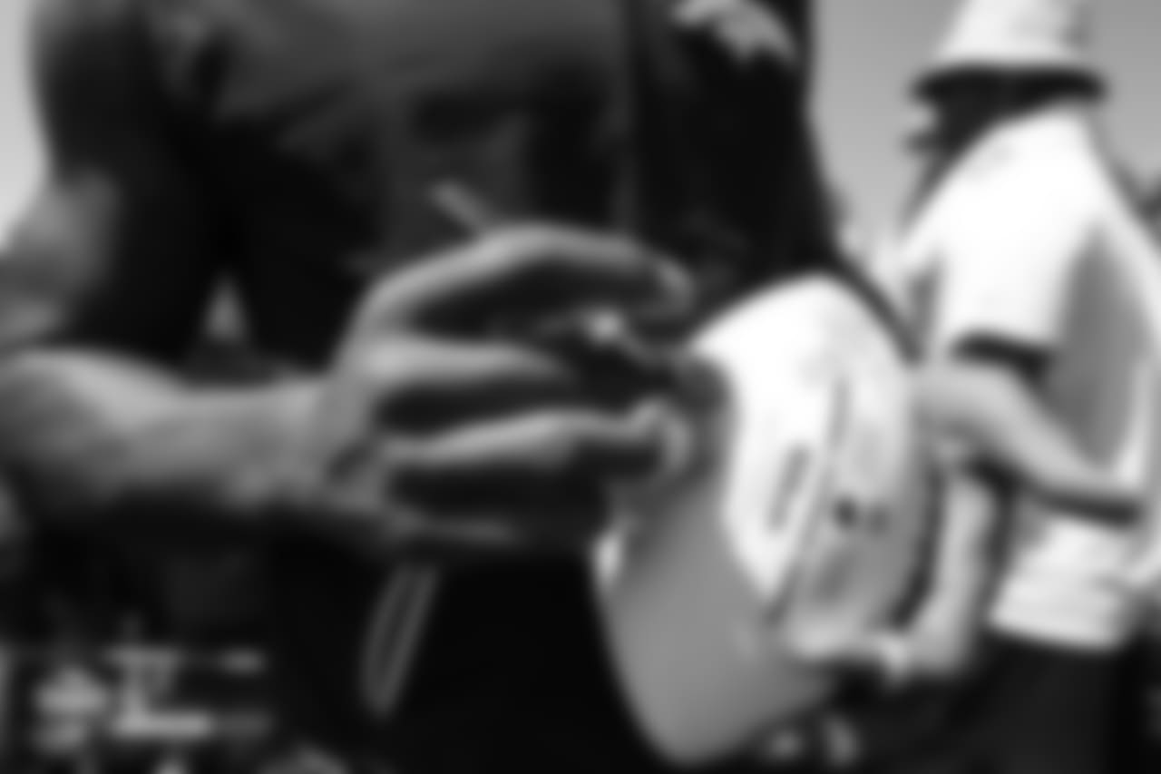 Wide receiver Demaryius Thomas (88) autographs a football afterthe 11th day of training camp on August 9, 2018, at UCHealth Training Center.