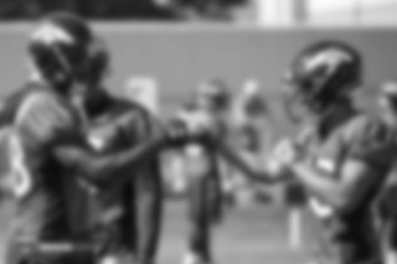 Wide receiver Demaryius Thomas (88) gives a fist bump to wide receiver Mark Chapman (85) during the 11th day of training camp on August 9, 2018, at UCHealth Training Center.