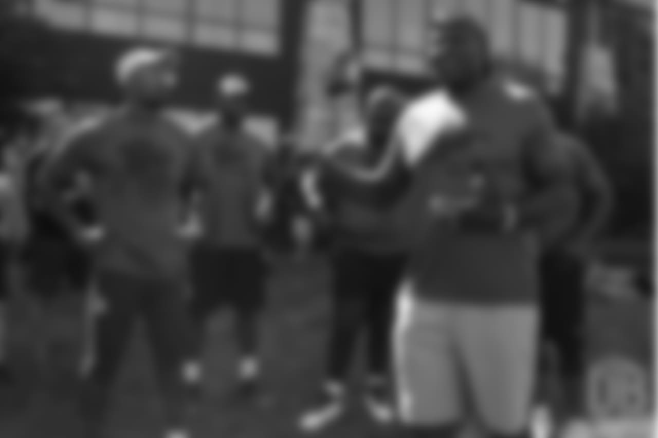 Von Miller listens as Bruce Smith gives instruction during the on-field portion of Von Miller's Pass Rush Summit, which included hands-on instruction and drills, on June 28, 2018.