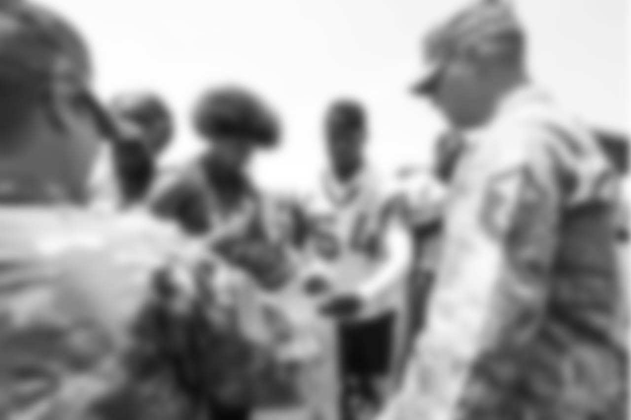 Wide receiver Kenny Bell (13) and inside linebacker Brandon Marshall (54) meet military members of the Colorado Air National Guard and the U.S. Army after practice on June 12, 2018. The meet-and-greet was part of an event hosting servicemen and servicewomen with USAA and the Broncos Womens Organization.